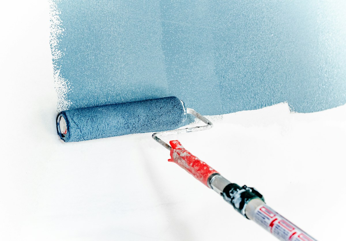 Painter applying a fresh coat to an interior wall