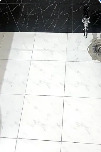 Tile floor with a dull dirty film before cleaning, and the same tile floor machine scrubbed and clean
